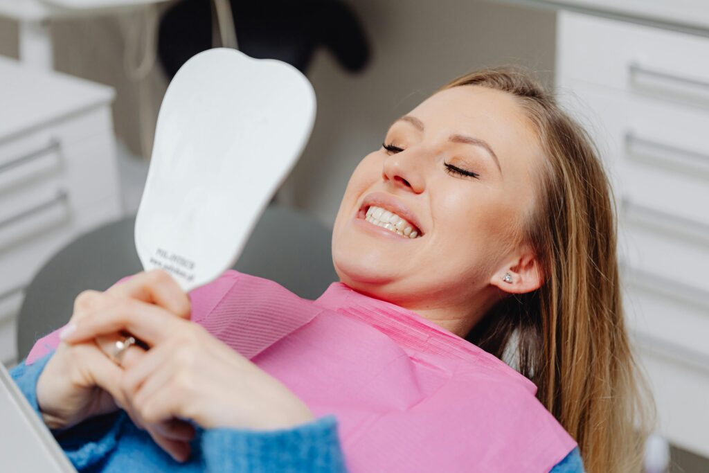 Smiling patient after dental implant treatment in Izmir