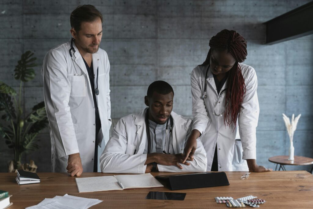 Health Tourism Expert Advice Three health professionals discussing medical travel options with a patient.